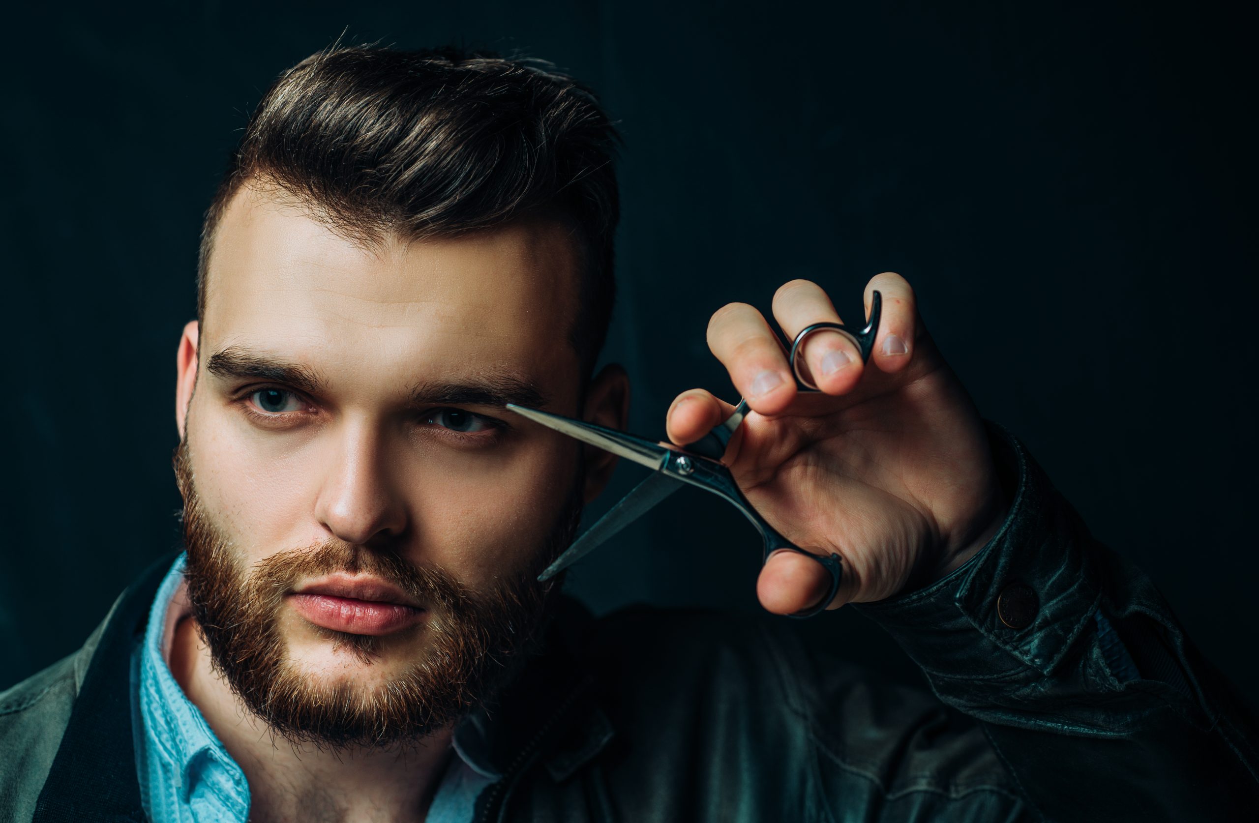 https://goldenpointsalon.com/wp-content/uploads/2024/07/young-sexy-man-portrait-guy-with-barber-scissors-barber-shop-modern-barbershop-shaving-handsome-male-with-modern-hairstyle-black-scaled.jpg